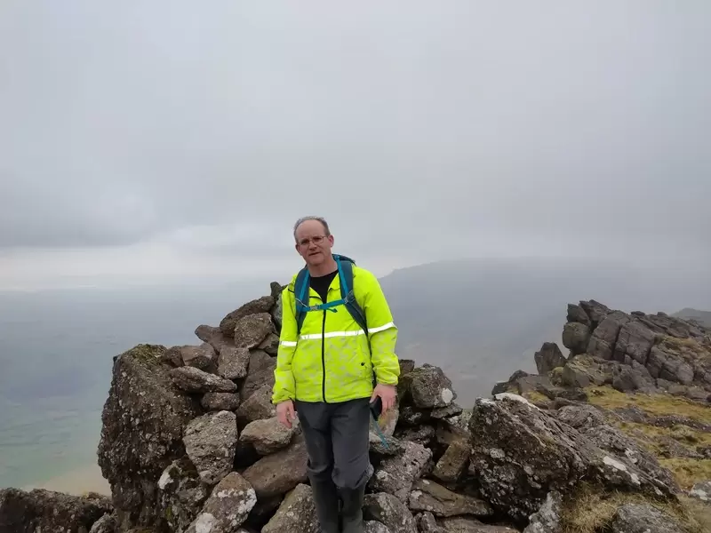 Dad standing at the top of Knockanaffrin
