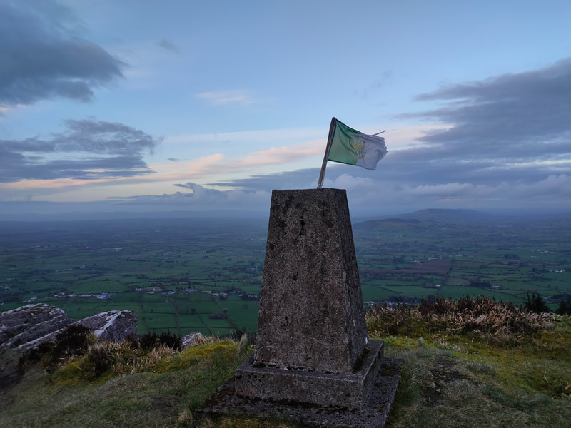 Trig pillar with Limerick Flag on Slievereagh