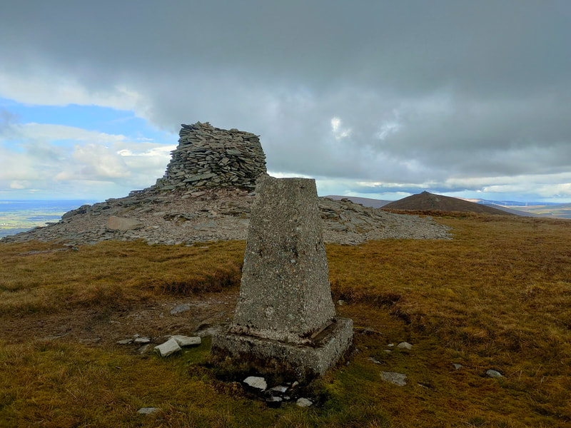 Mound of stones and Trig Pillar marking the top of The Paps West