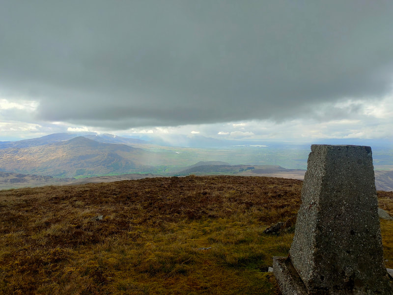 A dark sky over some Kerry Mountains from the Trig Pillar of The Paps West