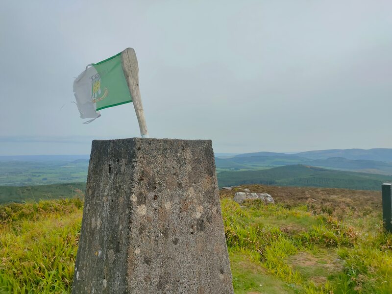 Green & white flag on top of  Slievereagh Trig pillar
