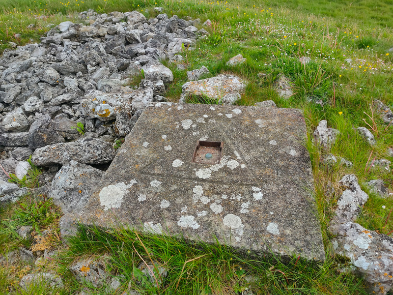 Square concrete slab with a triangle at the high point of Clomantagh Hill 
