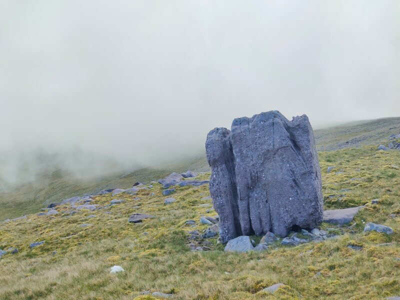 Large rock with low cloud in background