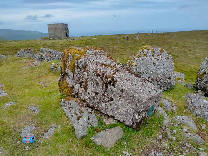 Seefin Trig pillar knocked horizontal and square shed in background