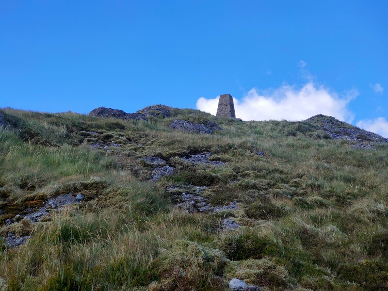Grassy and rocky top of Knocksheegowna with Trig Pillar