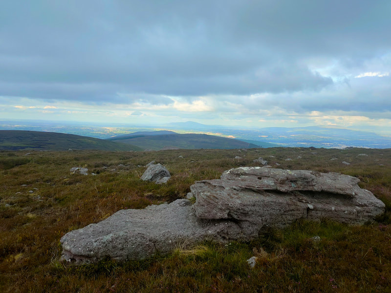 Large rock at the high point of Laghtshanaquilla against a grey sky
