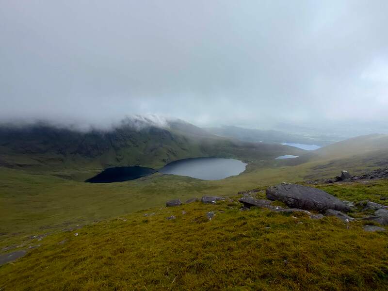 four lakes under mountain with low cloud