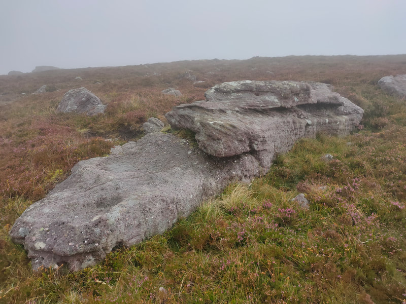 Large roick marks the top of Laghtshanaquilla on the brownish grassy mountain