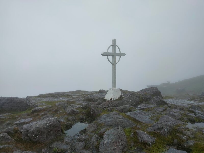 White Celtic Metal Cross on Galtymore in overcast conditions