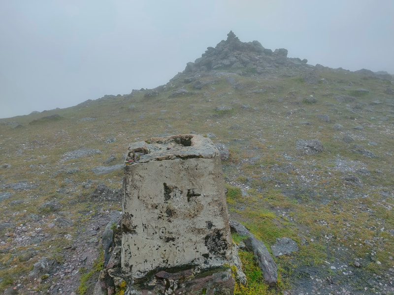 Trig Pillar of Galtymore stone cairn in background