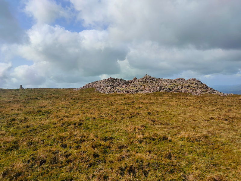 Large stone cairn on Knockshanahullion with Trig pillar off to the side
