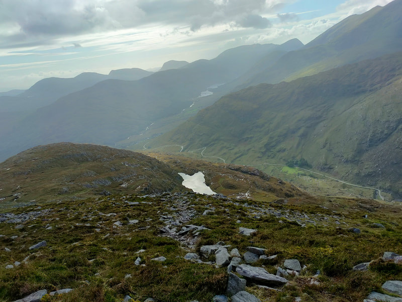 tiny lake on the side of Cnoc na dTarbh with The Black Valley below.