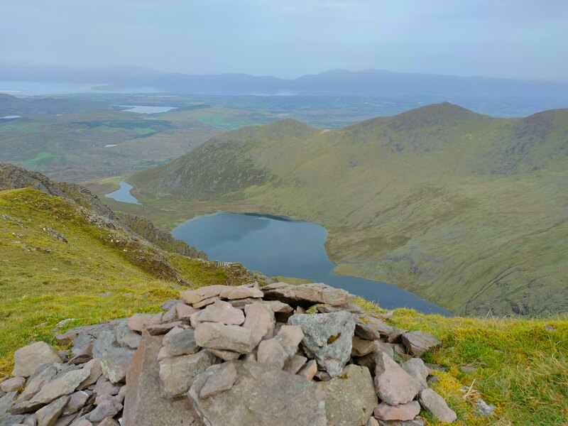 Small pile of stones marking the top of Caher looking down on the lakes below