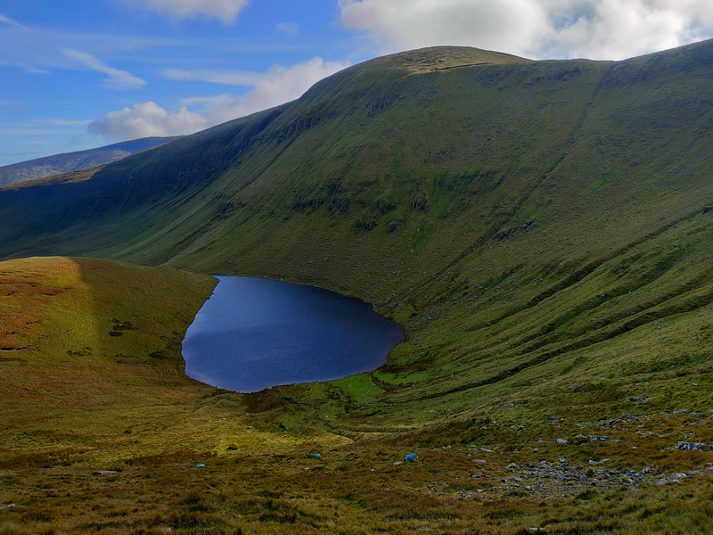 Bohereen Lough surrounded by green mountain sides