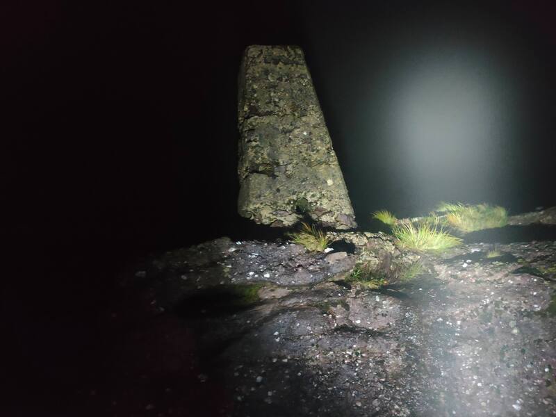 Trig Pillar in the light of the head torch