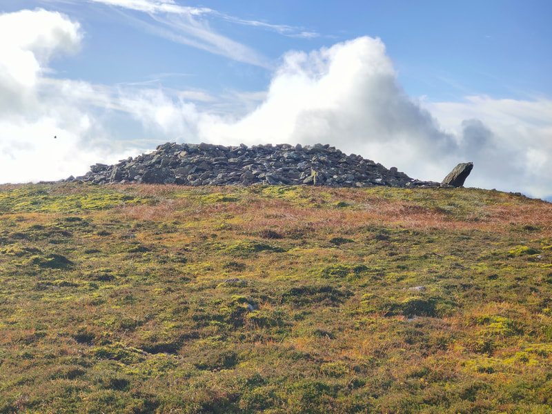 Large cairn of stones and lage standing stone at the top of Knocknafallia East