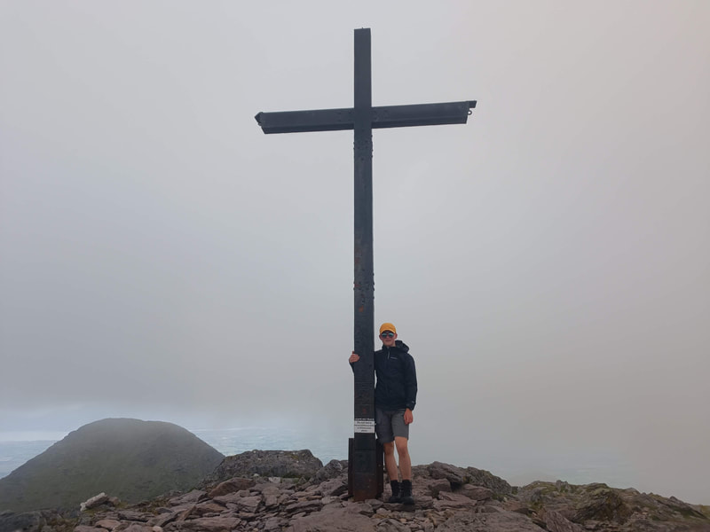 Dillon standing at the Cross of Carrauntoohil
